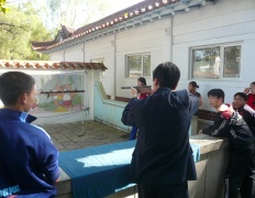 North Koreans in Sariwon playing a shooting game, North Hangh province, North Korea
