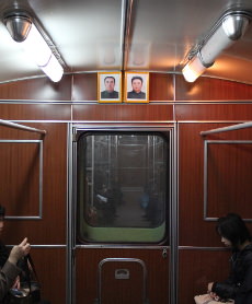 Portraits of the Leaders Kim Il Sung and Kim Jong Il in of the carriages in the Pyongyang Metro.