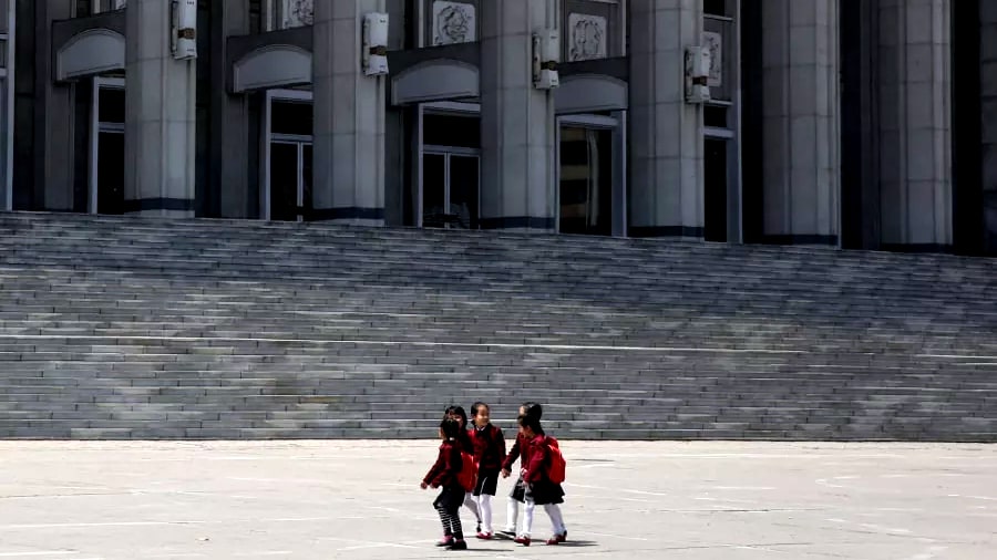 North Korean children marching in a street rally in Hamhung