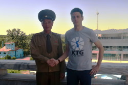 North Korean soldier at the DMZ shaking hands with KTG Tours staff member