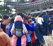 North Korean family in Moran Park with a western traveller from KTG during the leader Kim Il Sung's Birthday