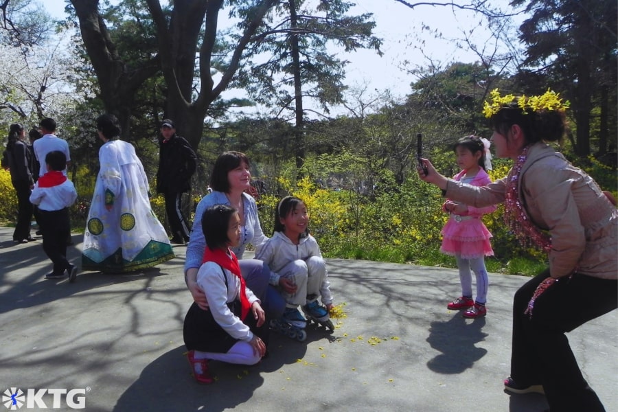 North Korean ladies laughing and celebrating Labour Day i.e. May Day with KTG travellers in Moran Park. Moranbong park is located in the centre of Pyongyang capital of North Korea, the DPRK. Picture taken by KTG Tours experts in DPRK North Korea tours.