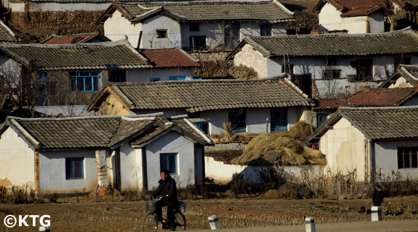 Man riding a bike in the countryside in North Korea (Democratic People's Republic of Korea). Tour arranged by KTG Travel