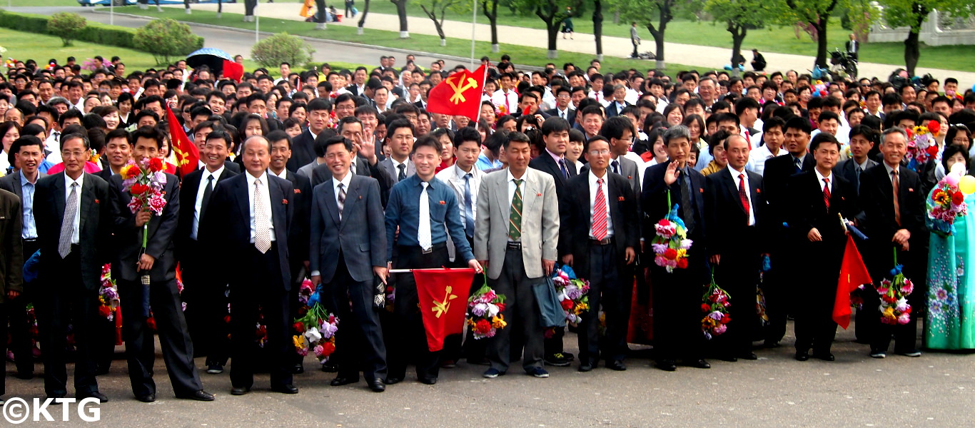 North Koreans with the party flag