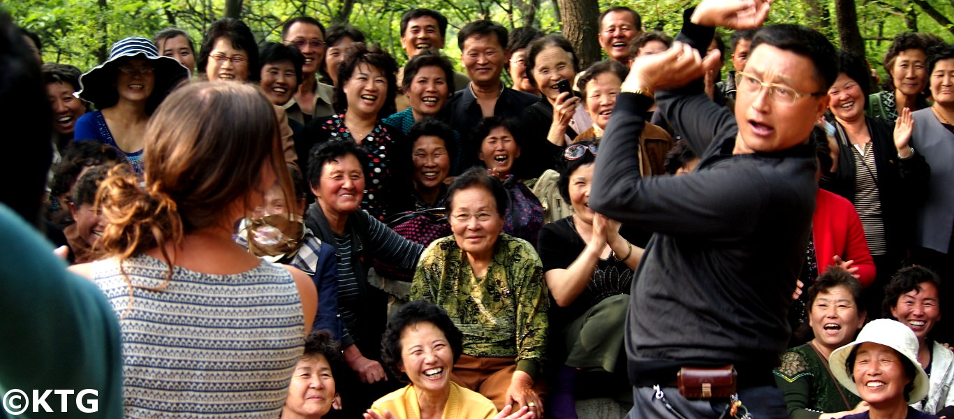 Korean man dancing in the park with a KTG traveller