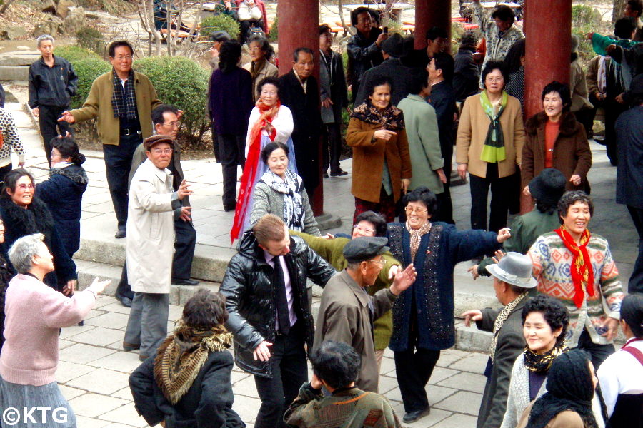 North Koreans dancing with Westerner
