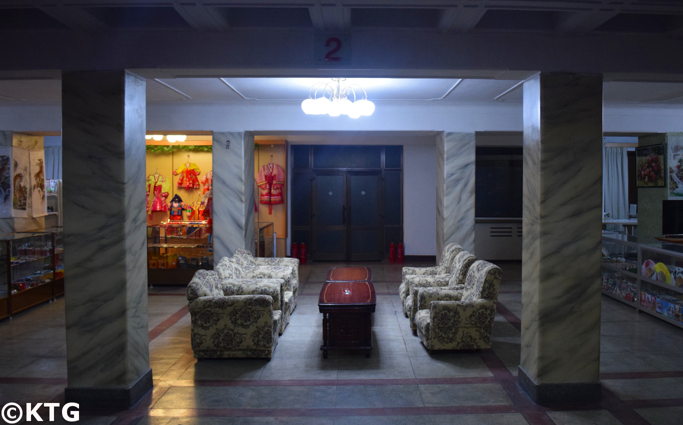 Retro sofas by the souvenir shop and bookstore at the Pyongyang Hotel, a second class economy hotel in North Korea