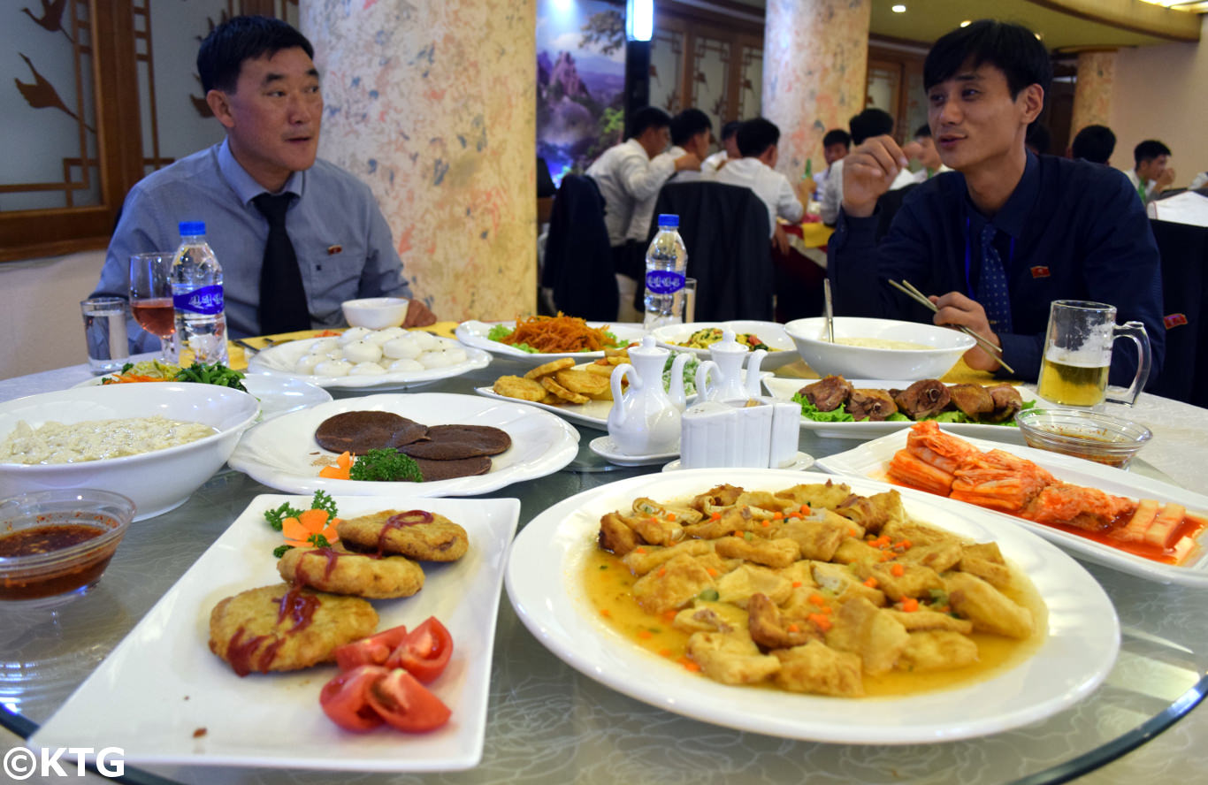 Kim Il Sung university students at a restaurant in the Lotus building in Romyong street in Pyongyang. This street was built in 2017 as if one of the most modern streets in Pyongyang and in all of North Korea (DPRK). Discover it with KTG Tours!