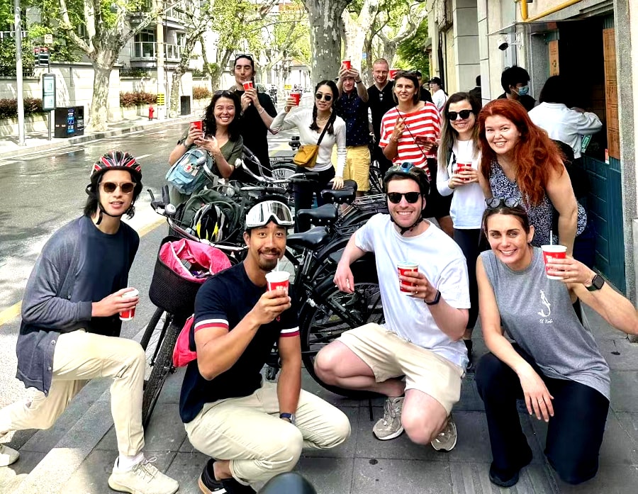 Having a local Shanghainese drink in Shanghai, China, on our bike & food tour of Shanghai