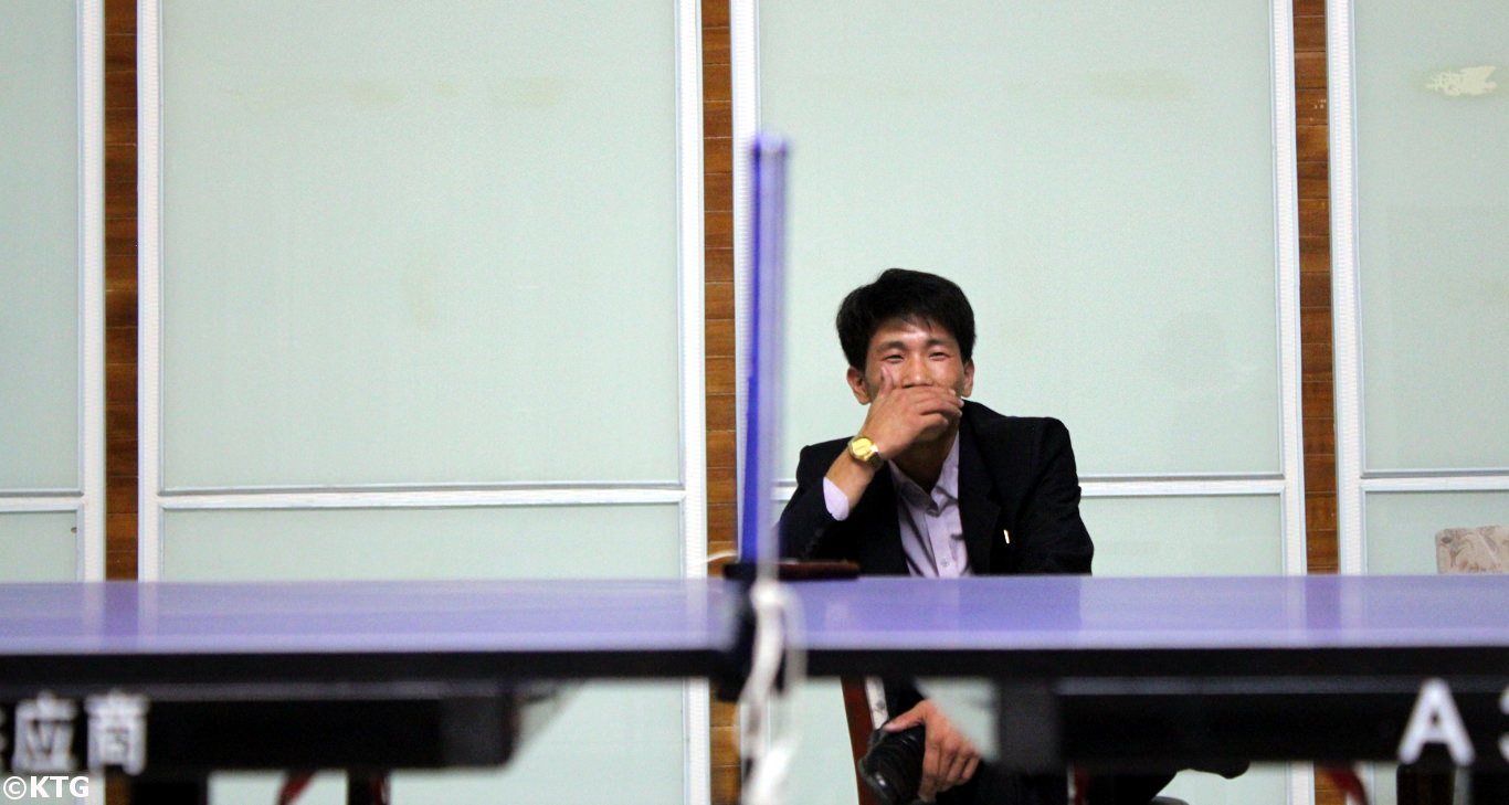 North Korean driver having a laugh watching a table tennis game at the Ryonggang Hot Spa Hotel in Onchon county near Nampo city, North Korea (DPRK)