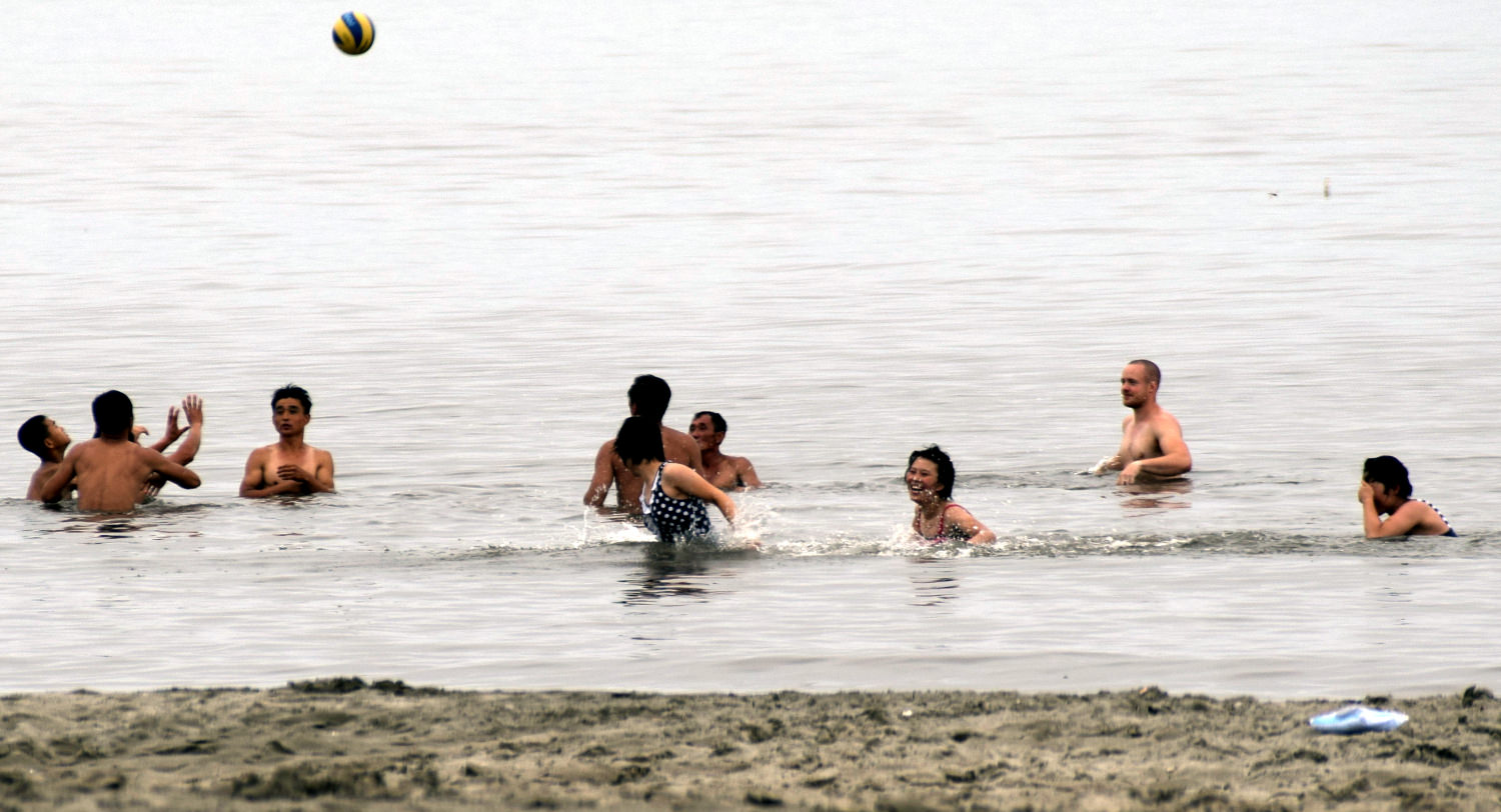 Playing volleyball at Songdowon beach in Wonsan with locals, North Korea