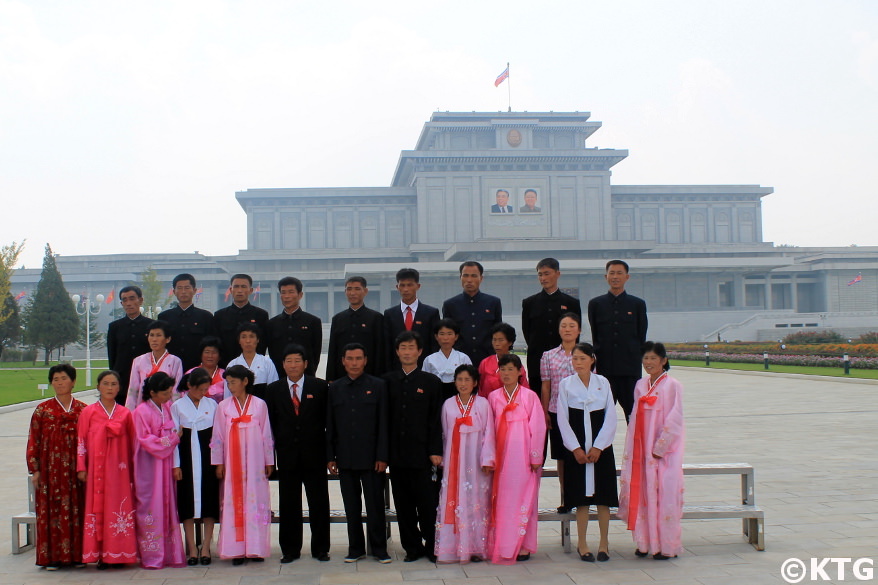 North Koreans taking a picture in the park at the Kumsusan Palace of the Sun in Pyongan capital of North Korea, DPRK. Trip arranged by KTG Tours