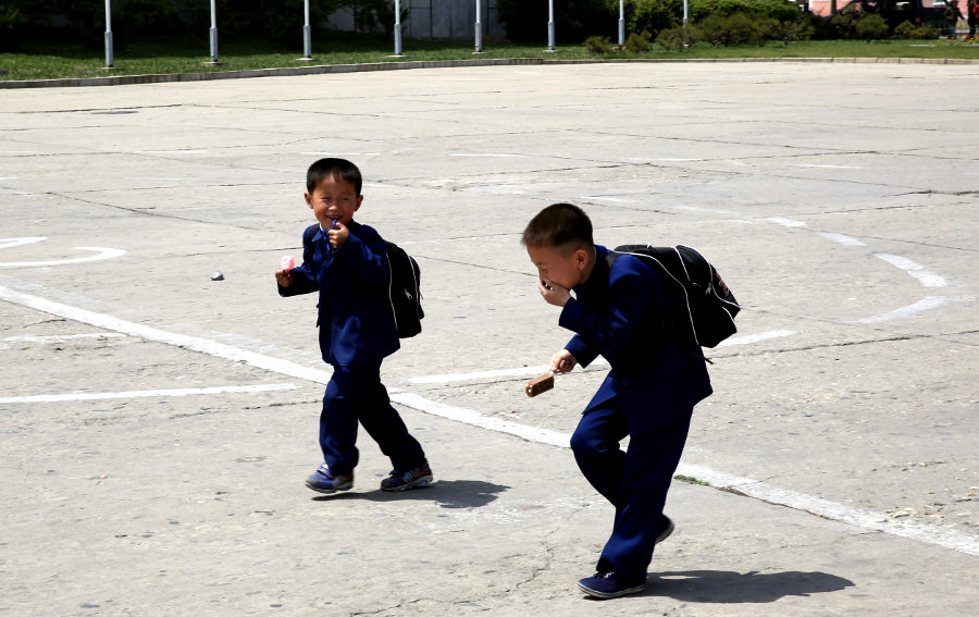 boys in Hamhung square in North Korea, DPRK. Trip arranged by KTG Tours