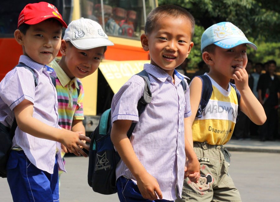 Curious North Korean children smiling at the sight of a Westerner