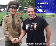 DPRK soldier shaking hands with a traveller in the ZDM, DPRK