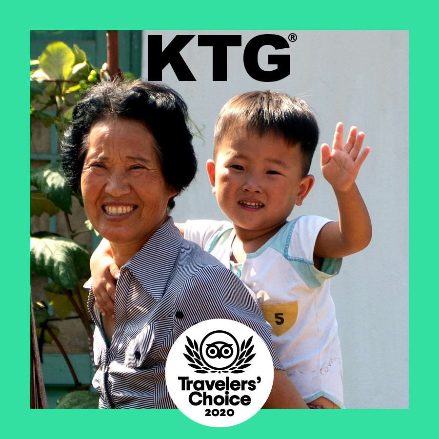 North Korean farmer and grandson at the Chongsan-ri cooperative farm near Nampo city in North Korea. Picture taken by KTG Tours