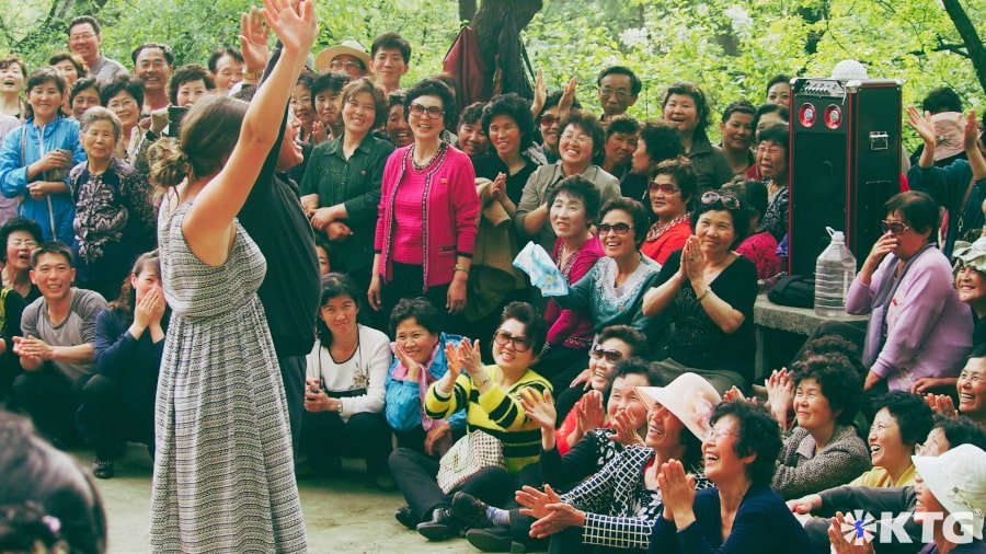 KTG western traveller dancing with North Korean man in Moranbong park ie Moran Hill in Pyongyang capital of North Korea on May Day i.e. Labour Day, a very important holiday in the DPRK.