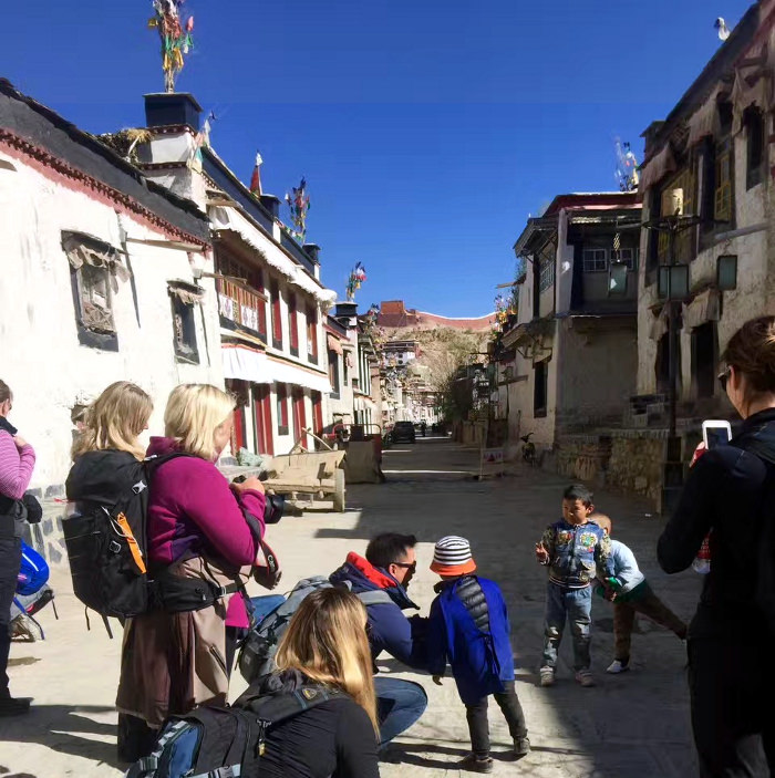 Taking pictures with locals in Gyanste, Tibet, China