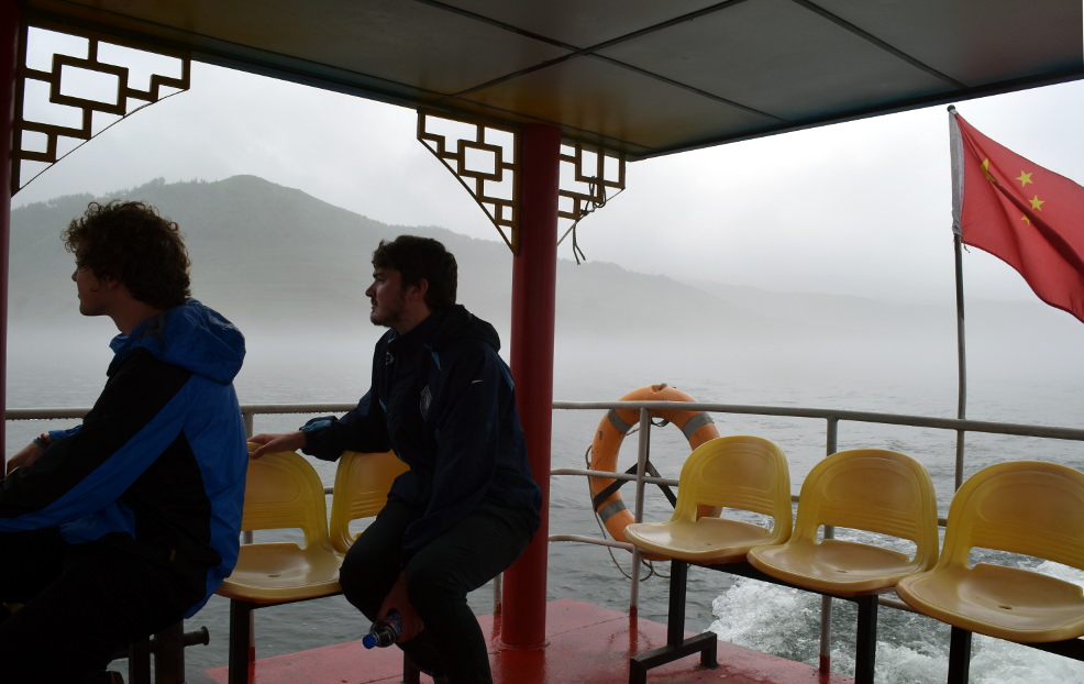 KTG tour leader Tim and traveller Zac at on boat take at Hekou, near Dandong, close to North Korea (DPRK)