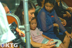 KTG traveller interacting with a North Korean girl in the Pyongyang metro