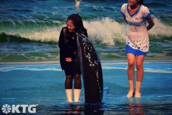 Dolphin kissing North Korean woman at the Rungna Dolphinarium in Pyongyang North Korea