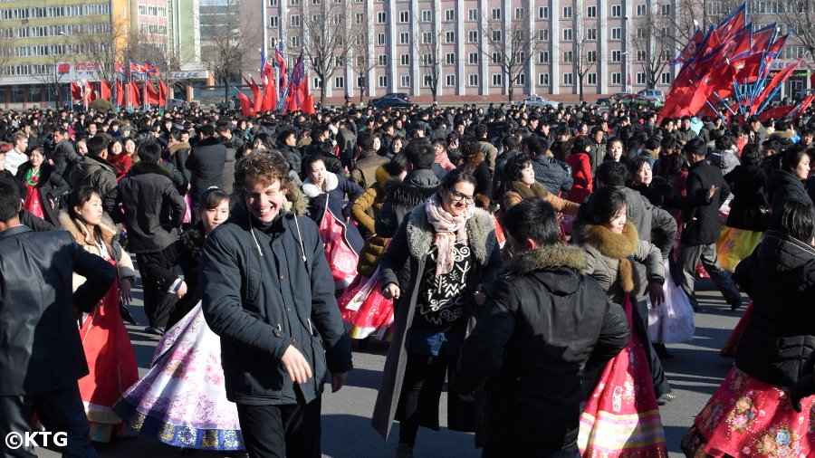 KTG staff member dancing with Koreans at the Mass Dances on Leader Kim Jong Il's Birthday in Pyongyang, North Korea (DPRK)