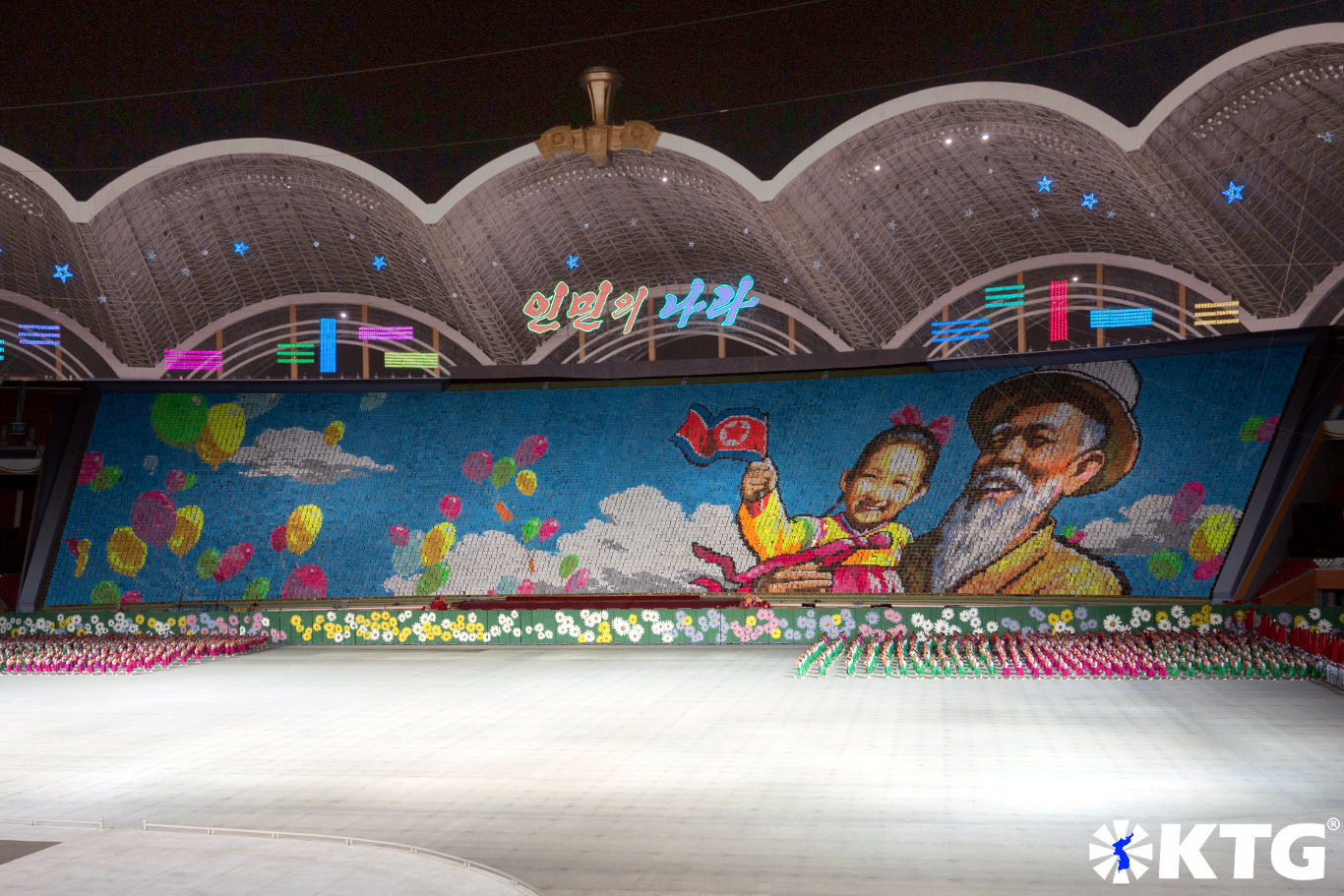 Giant mosaic backdrop of 17,000 students in the Rungrado May Day Stadium in Pyongang, form a scene of a North Korean grandfather and his granddaughter. Photo taken by KTG Tours