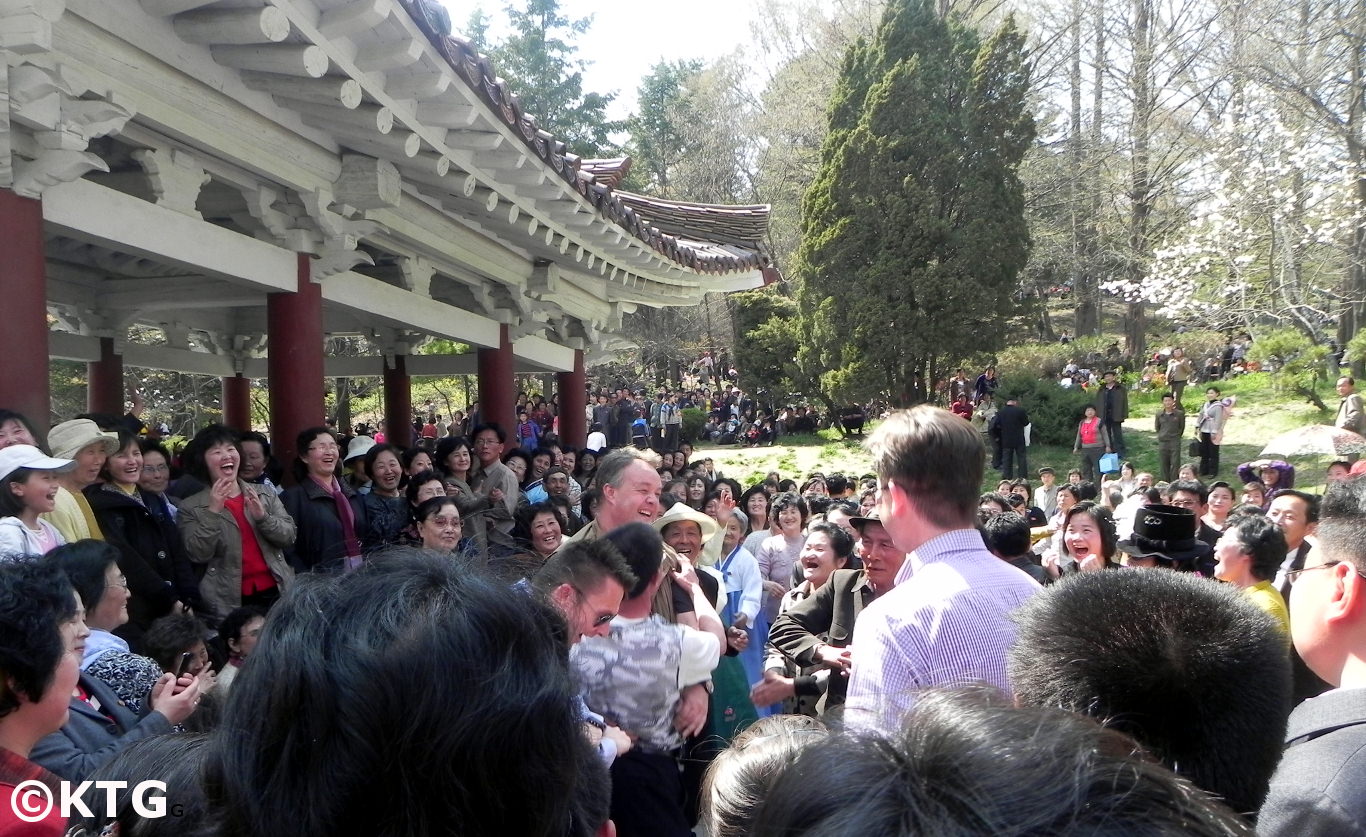 KTG travellers dancing with locals on May Day in Moran Park, Pyongyang capital of North Korea (DPRK)