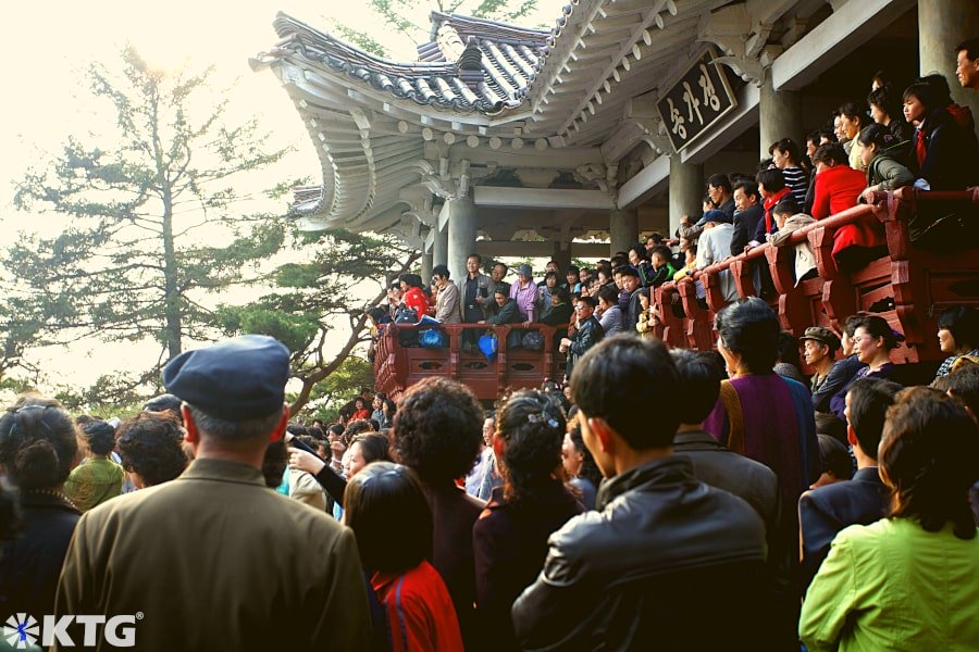 Hundreds of North Koreans dancing at a pavilion in Moran Hill i.e. Moranbong park in Pyongyang capital of North Korea on Kim Il Sung's Birthday. This is the most important holiday in North Korea. Picture taken by KTG Tours experts in North Korea tourism.