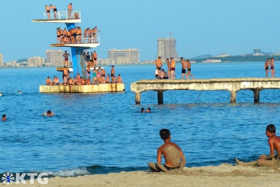 North Korean children having fun at the beach in Wonsan. You can see the Wonsa-Kalma beach resort project being built in the background.