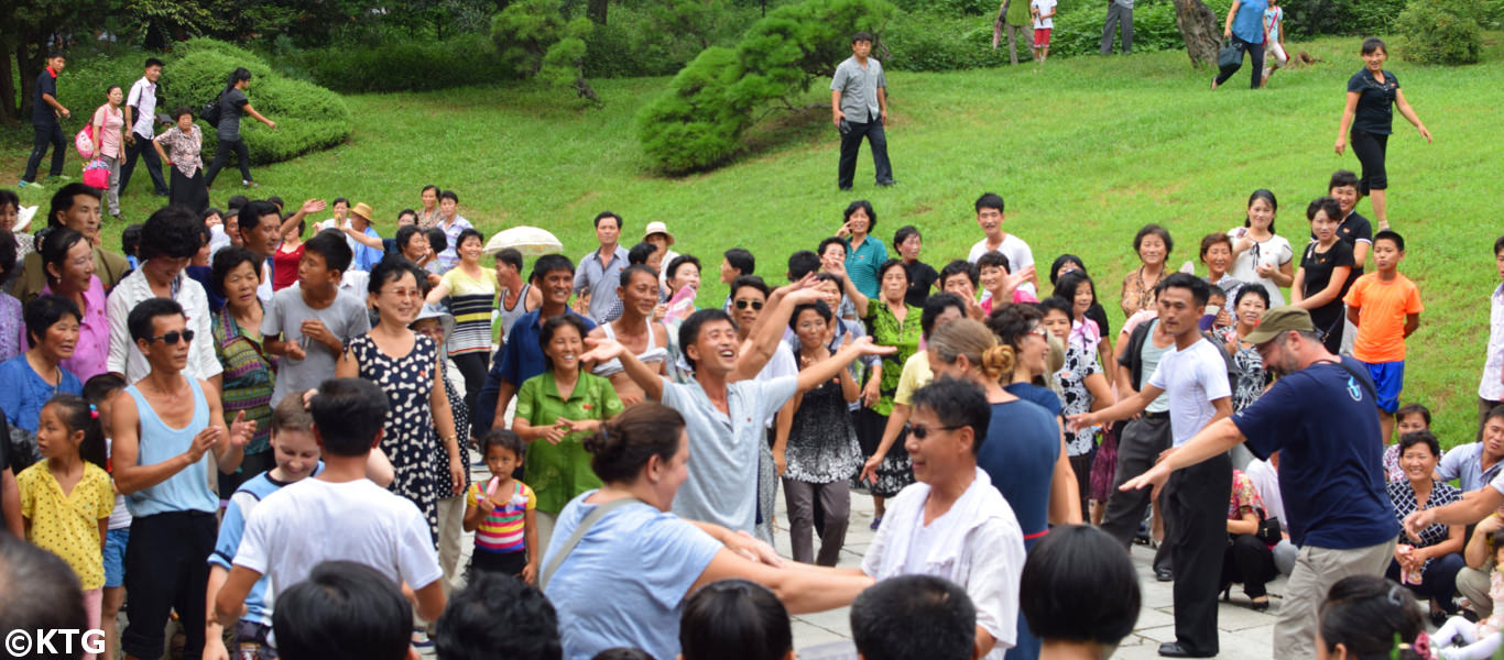 Viajeros de KTG bailando con locales norcoreanos en el parque Moran en la capital de Corea del Norte Pyongyang