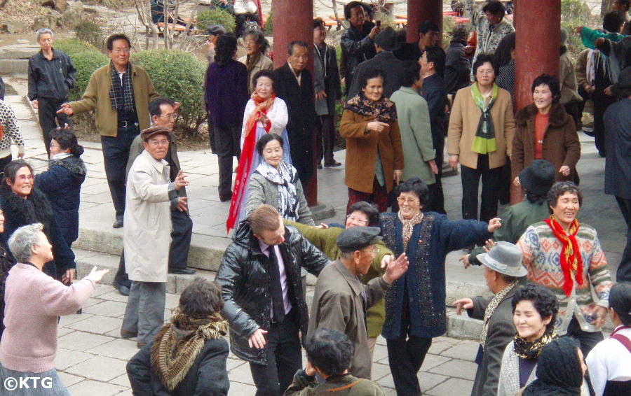 North Koreans dancing with a foreigner at Moran Park in Pyongyang