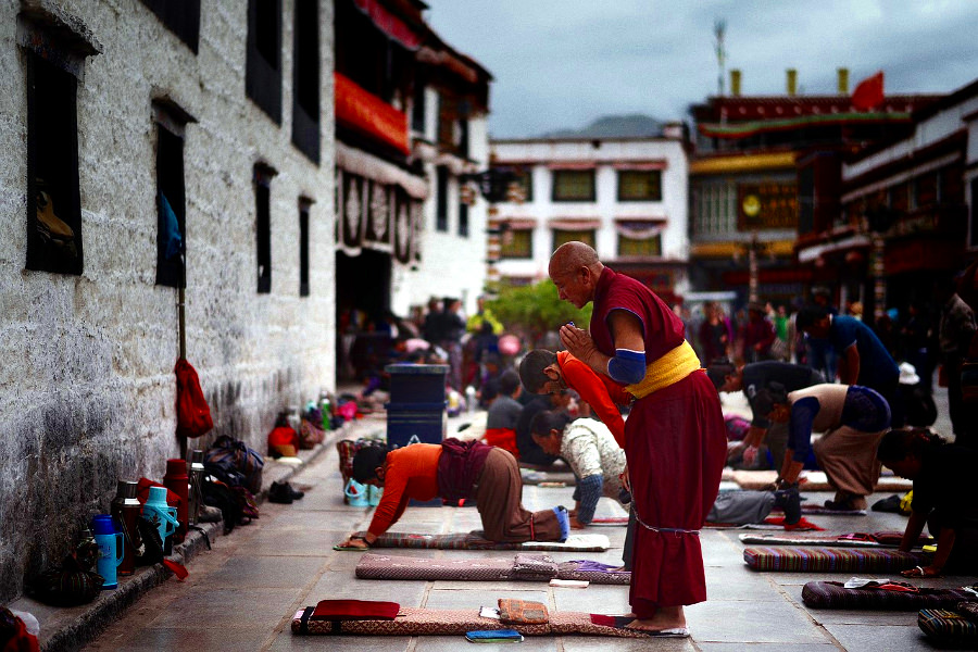 Pilgrims praying by Jokhang temple in Lhasa, Tibet, China