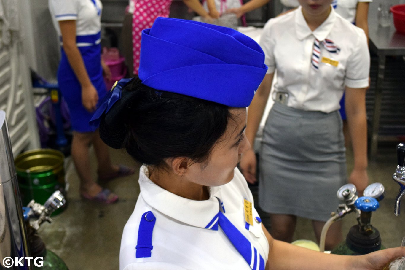 North Korean lady pulling a pint of beer. Visit the DPRK with KTG!