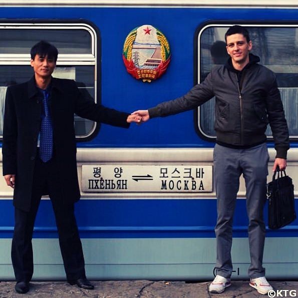 KTG staff member and North Korean guide by the train that goes from Pyongyang to Moscow