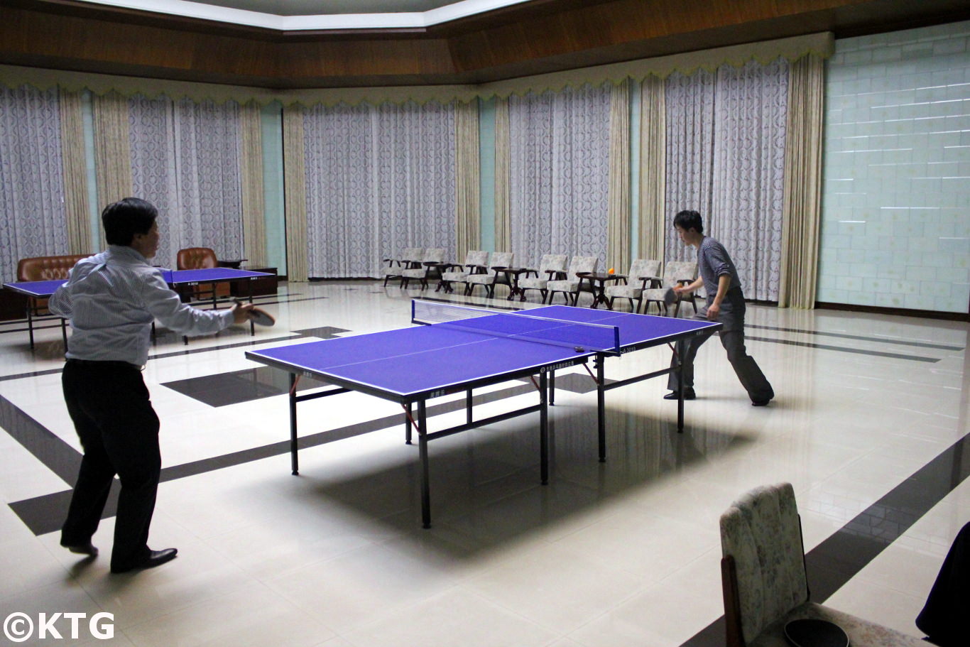 North Korean men playing table tennis at the Ryonggang Hot Spa Hotel near Nampo city in North Korea, DPRK. Picture taken by KTG Travel