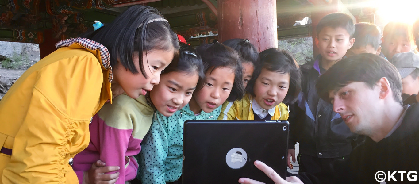 KTG staff member showing Korean children our DPRK 360 images