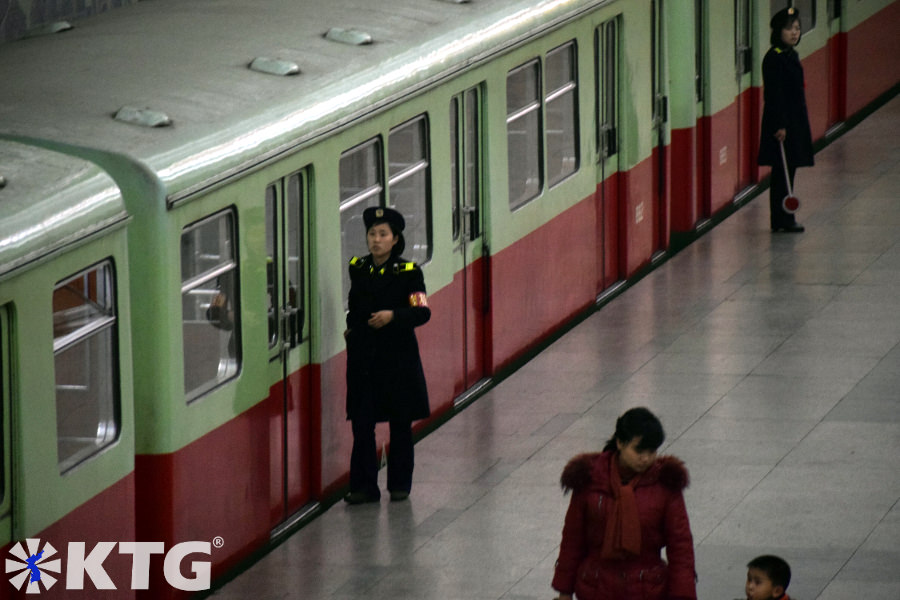 staff members of the Pyongyang metro, North Korea. Workers dress in military uniforms. Picture of North Korea taken by KTG Tours