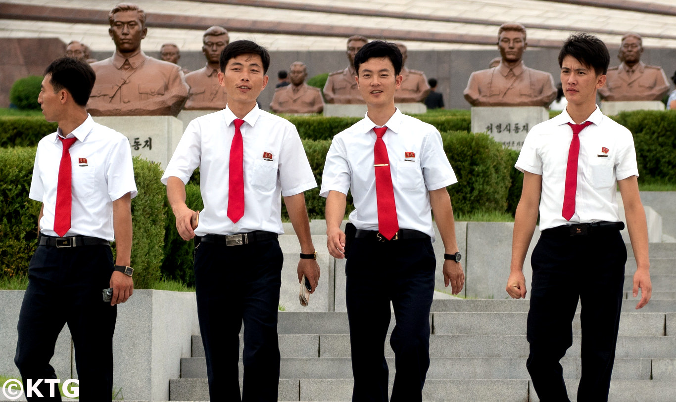 Family by the bust of Mother Kim Jong Suk at the Revolutionary Martyr's Cemetery Pyongyang, North Korea