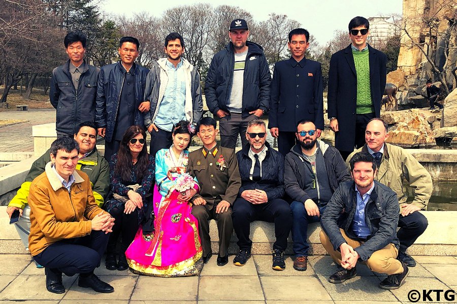 KTG group tour taking a picture in Pyongyang capital of North Korea with a recently married couple and their friends